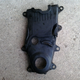 Old lower and middle timing covers. Note the grove worn through both of them on the side, thanks to the loose idler pulley. Also note the hole beneath that groove, where the timing pointer was worn away.